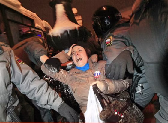Police officers detain an opposition activist during a banned anti-Kremlin protest in St. Petersburg, Russia, on Monday. Opposition groups have been calling rallies on the 31st day of each month to honor the 31st article of the Russian Constitution, which guarantees the right of assembly. Most of the rallies have been banned or dispersed by police as unsanctioned. 